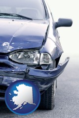 ak map icon and an automobile accident, hopefully covered by insurance